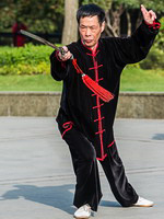 A man practicing Tai Chi in one of the parks of Shanghai, China
