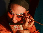 Chinese opera actor, does make-up before the show