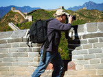 Tourist photographing scenic beauty opening out of the height of the Great Wall of China