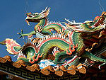 The figure of a dragon on the roof of a Chinese temple title=