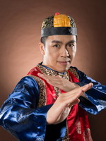 A Chinese man in traditional dress, showing one of the attacking poses of the Chinese Kung Fu