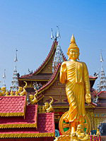 Figure of Buddha against the Buddhist Palace in Xishuangbanna, China